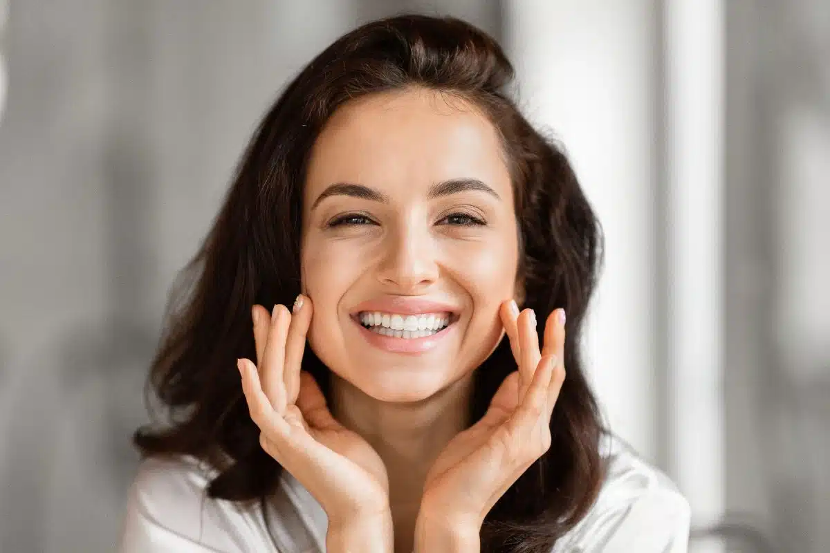Carence en magnésium et peau : femme souriante au teint lumineux et sans imperfection Carence en magnésium et peau : femme souriante au teint lumineux et sans imperfection