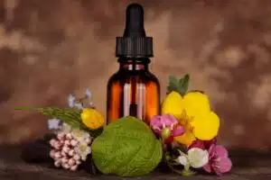 Fleurs de Bach ménopause flacon d'elixir floral entouré de fleurs colorées, émotions