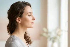 Rhinoplastie ratée : femme de profil au visage serein, lumière douce sur la ligne du nez